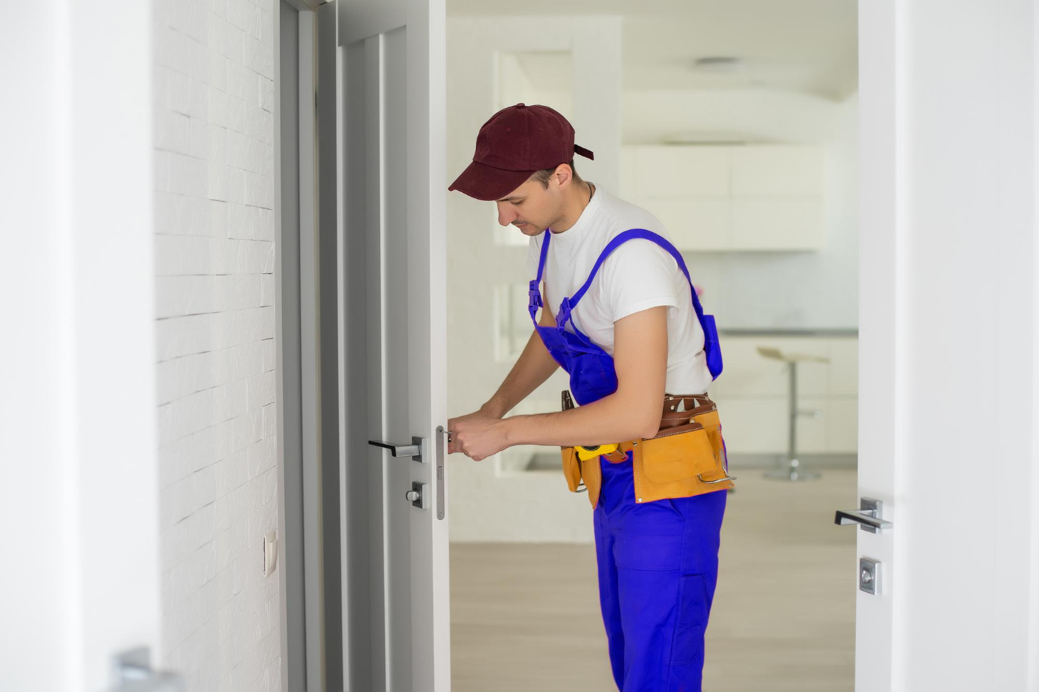 master-worker-installs-door-lock-front-door-metal-doors-with-polymer-coating